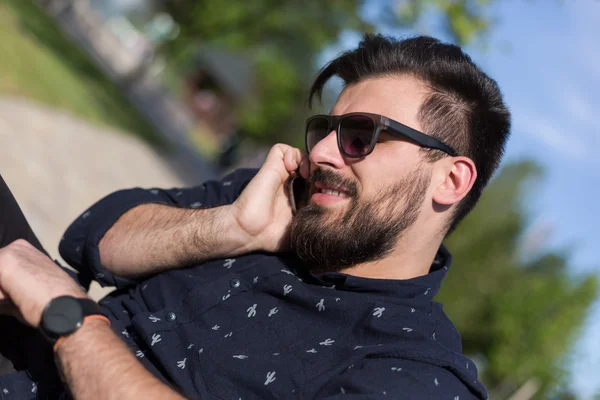 Jovem barbudo homem falando no smartphone — Fotografia de Stock