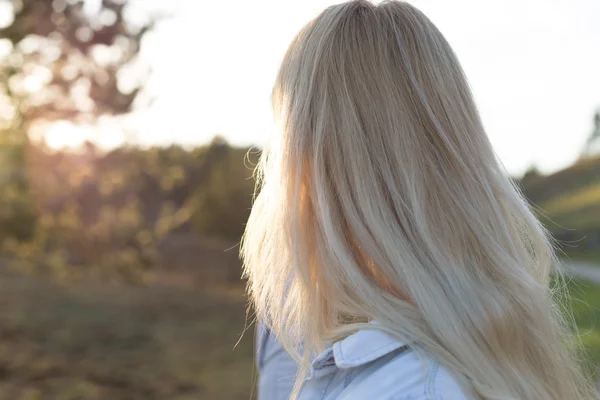 Блондинка в полі на заході сонця — стокове фото