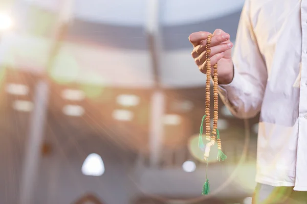 Hand holding a muslim rosary — Stock Photo, Image