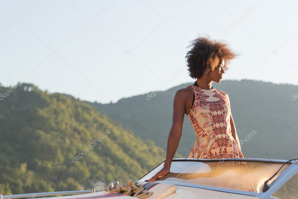 afro woman driving a speedboat 