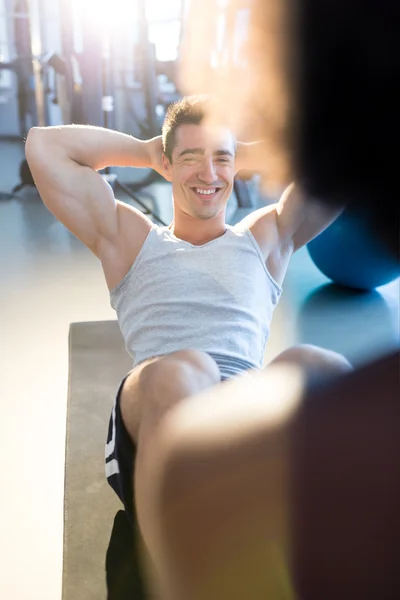 Hombre y mujer haciendo ejercicio en el gimnasio — Foto de Stock