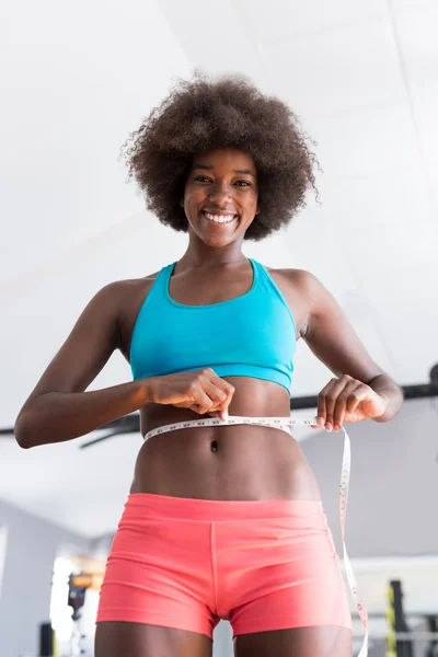 Kvinna mäta midjan i gymmet — Stockfoto