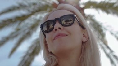 woman enjoying under the palm tree