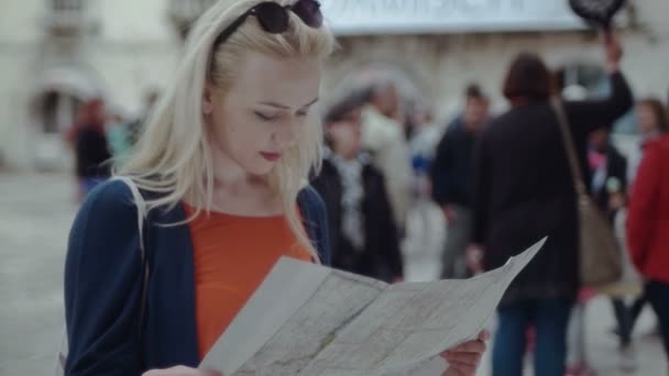 Mujer turista mirando en el mapa tratando de orientar — Vídeo de stock