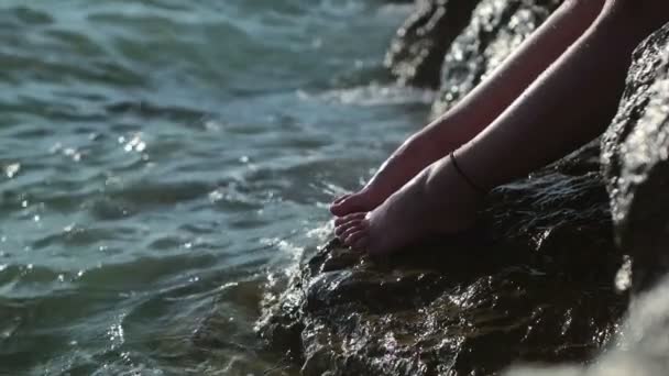 Ragazza in piedi sulla scogliera e spruzzato con acqua, Ragazza vicino al mare godendo il sole — Video Stock