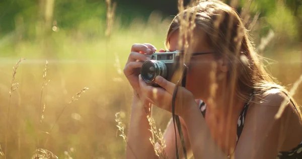 Menina tirando fotos com câmera vintage — Fotografia de Stock