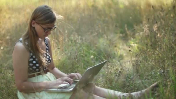 Mädchen mit ihrem Laptop in der Natur — Stockvideo