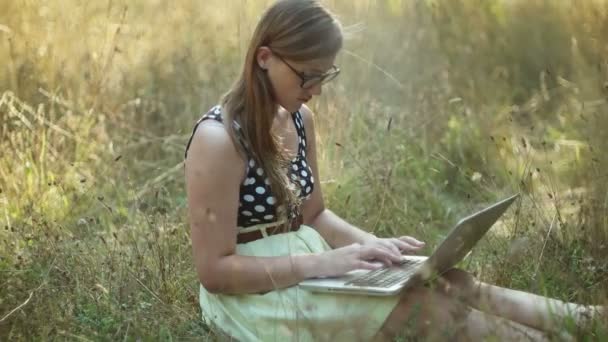 Mädchen mit ihrem Laptop in der Natur — Stockvideo