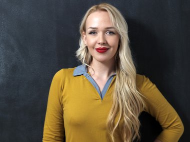 Karanlık yazı tahtası önünde duran beyaz kadın. Gülümseyen