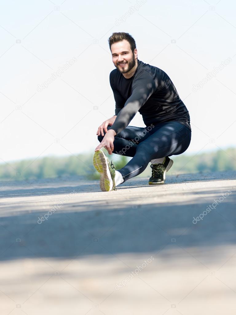 Runner doing streching outside