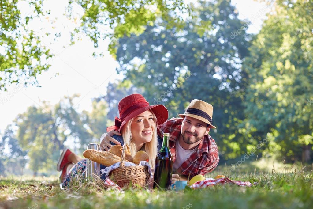 Beautiful Young Couple Having Picnic in Countryside. Happy Family