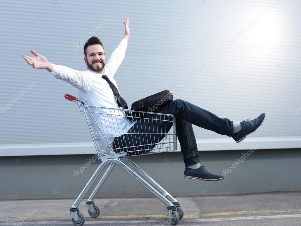 businessman driving in the shopping cart