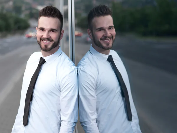 Empresário bonito amigável e sorridente olhando com confiança para a câmera — Fotografia de Stock