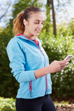 Genç sportif kadın Parkı'nda bir Selfie alarak. Sm bakıyor