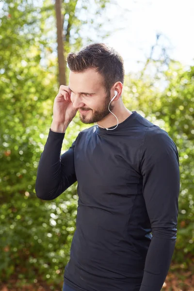 Handsome sporty man  tired runner resting after evening jog, fit — Stock Photo, Image