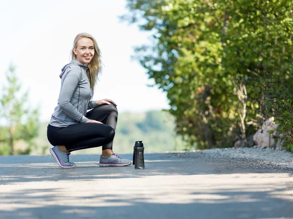 Portrait of female runner in nature after jogging — Stock Photo, Image
