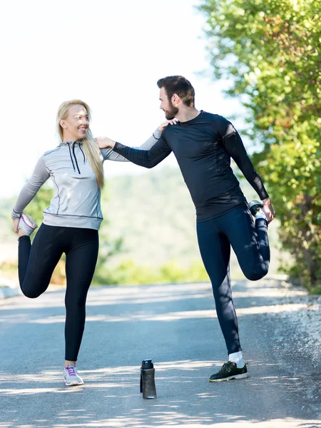 Portrait of cheerful Caucasian couple running outdoors. Runners — Stock Photo, Image