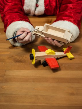 Noel Baba bir oyuncak uçak boyama atölyesinde oturmuş. Hor