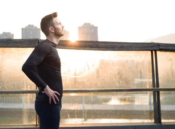 Athletic Handsome Man in Black Workout Clothing Running at the R — Stock Photo, Image