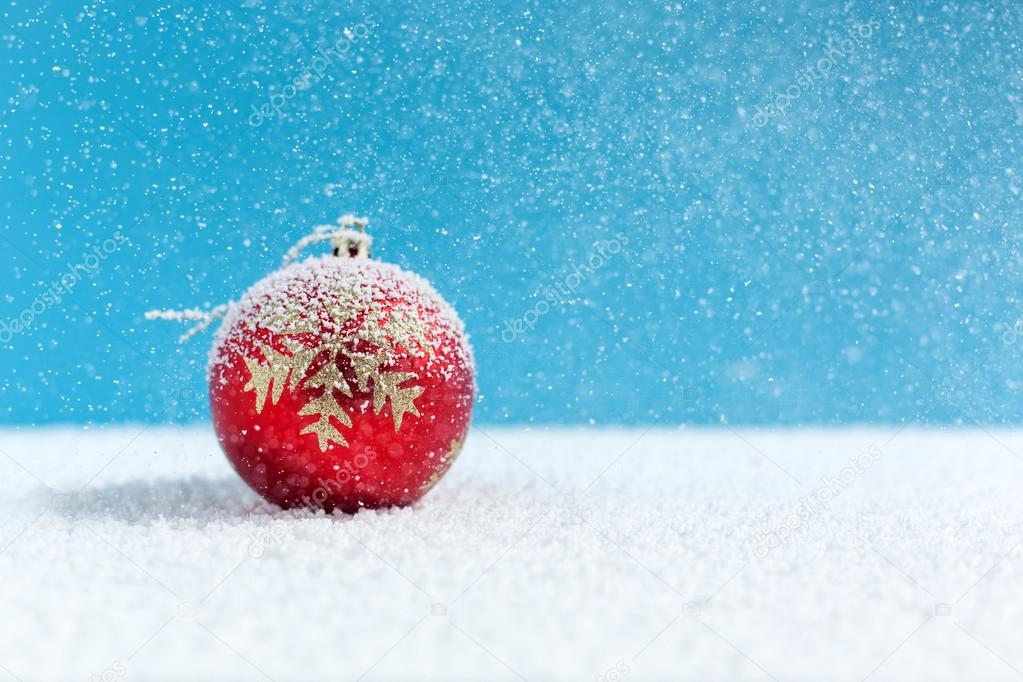 Christmas balls on snow, falling snow