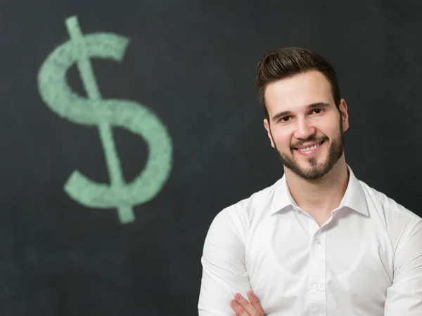 Man standing in front of dollar sign — Stock Photo, Image