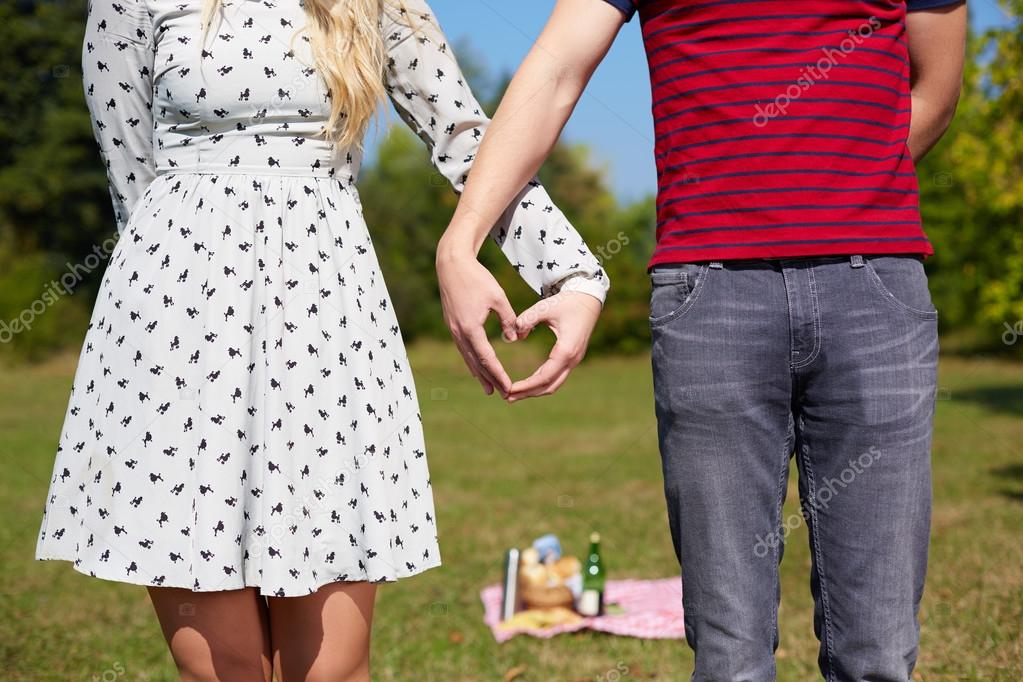 Valentines couple make heart shape with hands