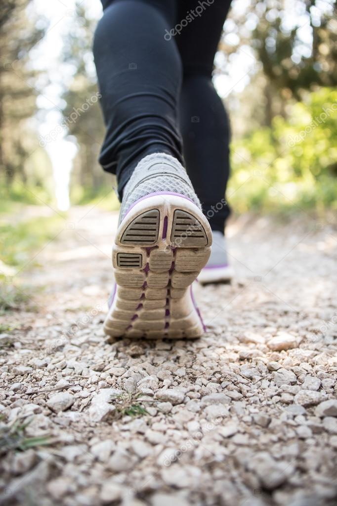 Sport shoes on trail walking in mountains, outdoors activity