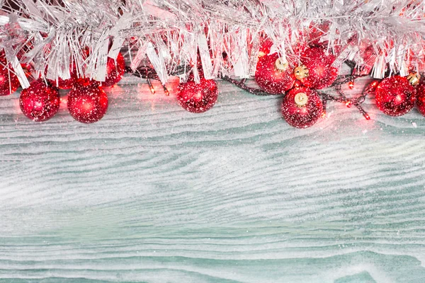 Gold Christmas bells and fir tree branch on a rustic wooden back — Stock Photo, Image