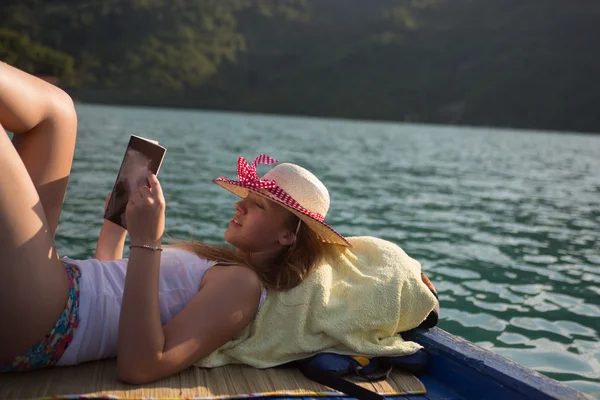 Hippi kız teknede bir kitap okuma — Stok fotoğraf