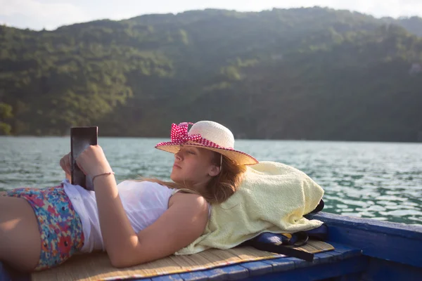 Hipster girl reading a book on the boat — Stock Photo, Image