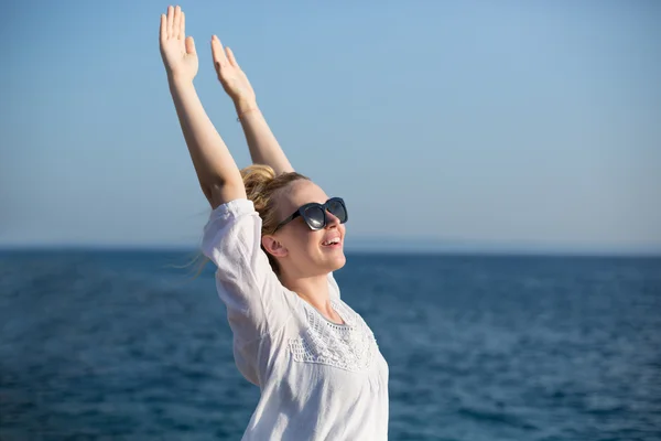 Young attractive woman near the ocean on a summer day Stock Picture