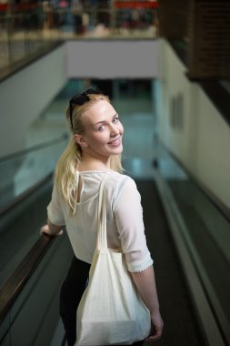 Neşeli oldukça genç bayan alarak yürüyen merdiven Ride ve shoppin