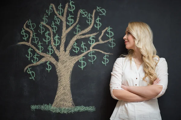 Happy blonde Business woman in front of chalk money tree drawing — Stock Photo, Image