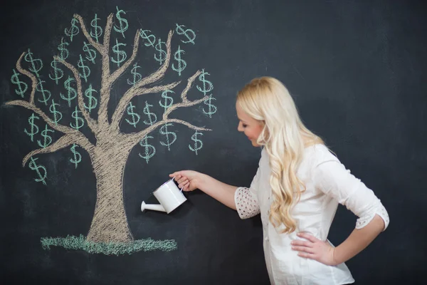 Happy blonde Business woman in front of chalk money tree drawing — Stock Photo, Image