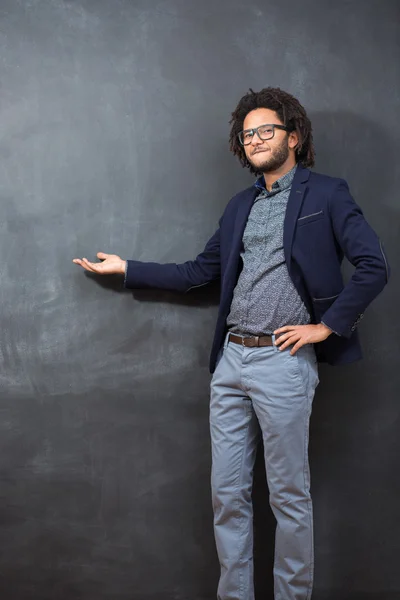 Pensive young African American man standing against a blank chal — Stock Photo, Image