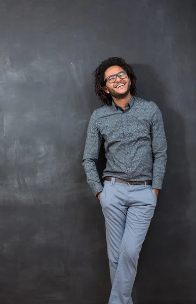 Pensive young African American man standing against a blank chal — Stock Photo, Image