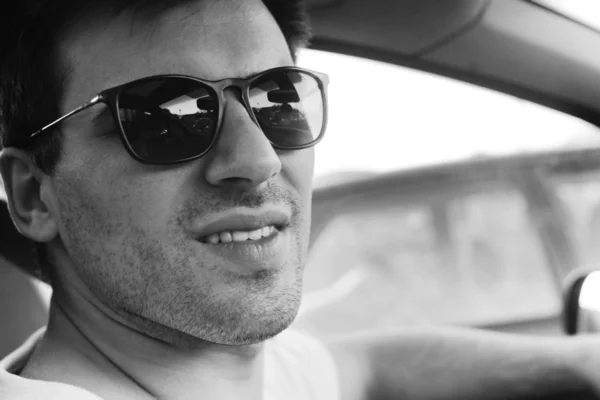 Side view of a young man driving his convertible car — Stock Photo, Image