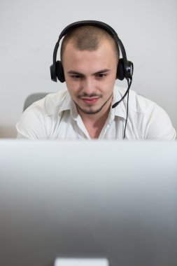 Casual genç adam bilgisayar kullanarak mezartaşı ile gülümseyen