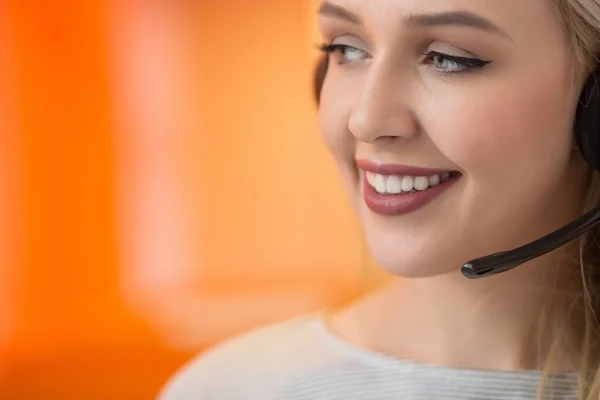 Close-up portrait of a customer service agent sitting at office — Stock Photo, Image