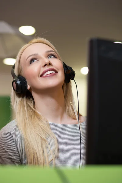 Aantrekkelijke jonge vrouw in pak zit op call center office en — Stockfoto