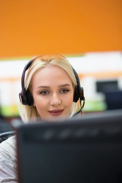 Attractive young woman in suit sitting at call center office and — Stock Photo, Image