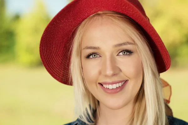 Portrait of romantic young woman with beautiful smile outdoors.