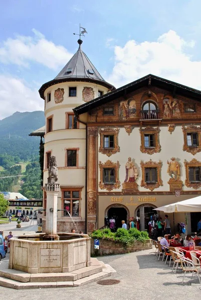 Berchtesgaden, Germany - 2013: Market Square Fountain (Marktplatz Brunnen) and iconic tower of the Deer House (Hirschenhaus). The lion lion statue is the symbol of the Wittelsbach family.