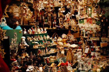 Erfurt, Germany: Handmade wooden ornaments are crowded into a Christmas Market (Weihnachtsmarkt) stall.  clipart