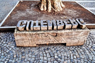 MAINZ, GERMANY: A bench carved to look like a printing press wood block of movable type. It sits in front of The Gutenberg Museum named after Johannes Gutenberg, inventor of moveable type.  clipart