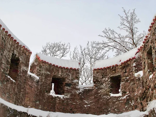 A frosty winter scene at Castle (Burg) Frankenstein, a hilltop castle overlooking the city of Darmstadt, Germany in Hesse. Inside of a castle keep with snow.