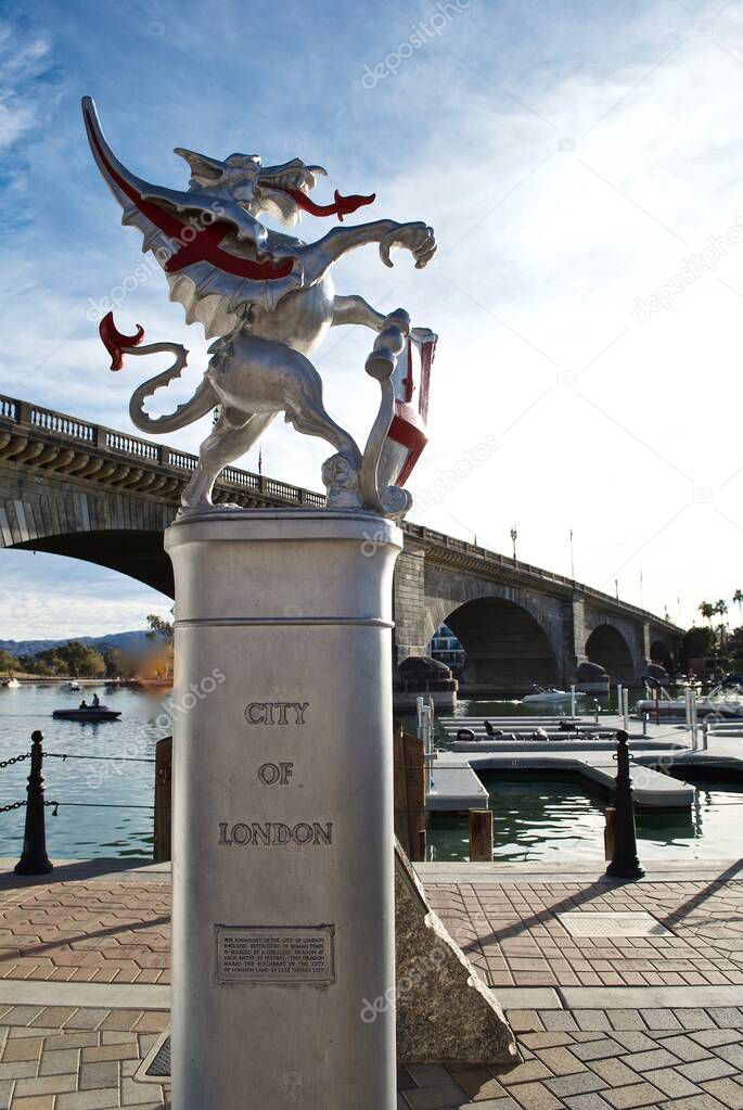 Lake Havasu City, Arizona: Replica Dragon Boundary Marker in front of the London Bridge. The dragons are painted silver with red details and hold City of London's coat of arms.