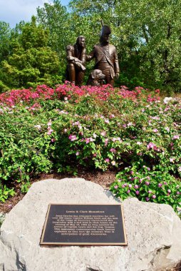 St. Charles, Missouri, USA: Lewis and Clark statue in Frontier Park near Missouri River. A bronze monument features Meriwether Lewis and William Clark and Clark's Newfoundland dog, Seaman. clipart