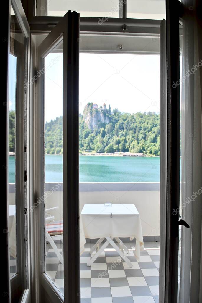 Lake Bled, Slovenia: View from inside the Grand Hotel Toplice. View of the Bled Castle (Blejski grad), a medieval castle built on a precipice above the city of Bled overlooking Lake Bled. 