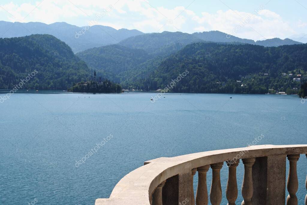 Lake Bled and Bled Island in Slovenia with Pilgrimage Church of the Assumption of Maria in the Julian Alps. As seen from Grand Hotel Toplice balcony. 